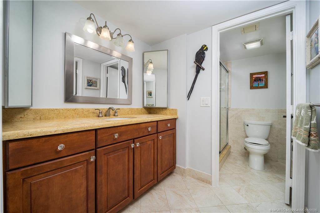 3100 Southeast Pruitt Road, Unit G205 Port St. Lucie, FL 34952 - Photo 18 of 29 a bathroom with a sink and a mirror
