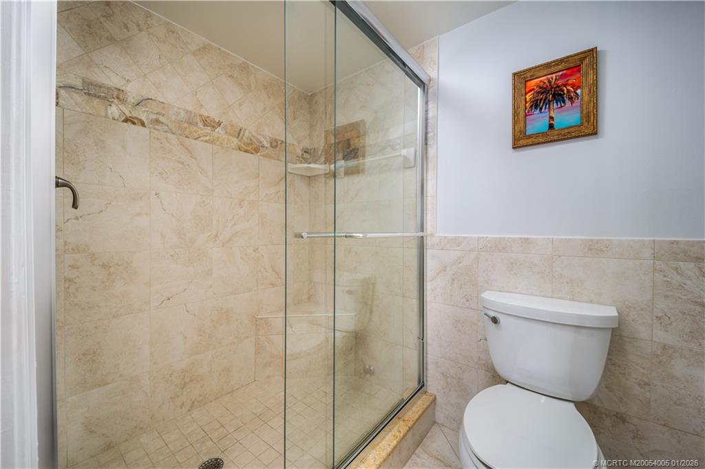 3100 Southeast Pruitt Road, Unit G205 Port St. Lucie, FL 34952 - Photo 19 of 29 a bathroom with a toilet and a shower