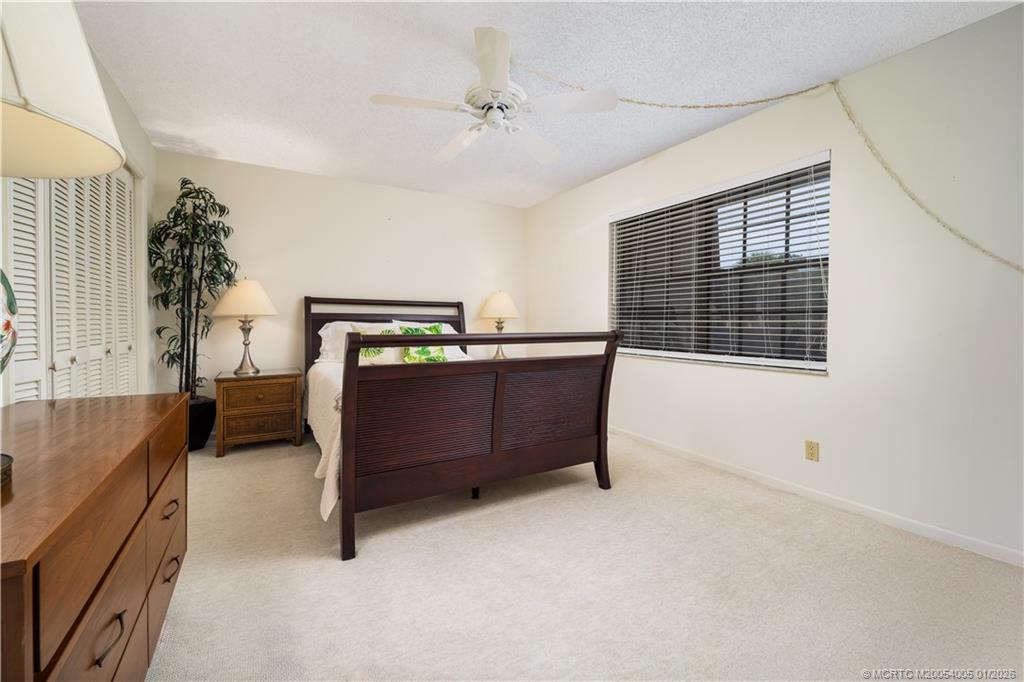 3100 Southeast Pruitt Road, Unit G205 Port St. Lucie, FL 34952 - Photo 20 of 29 a bedroom with furniture and a window