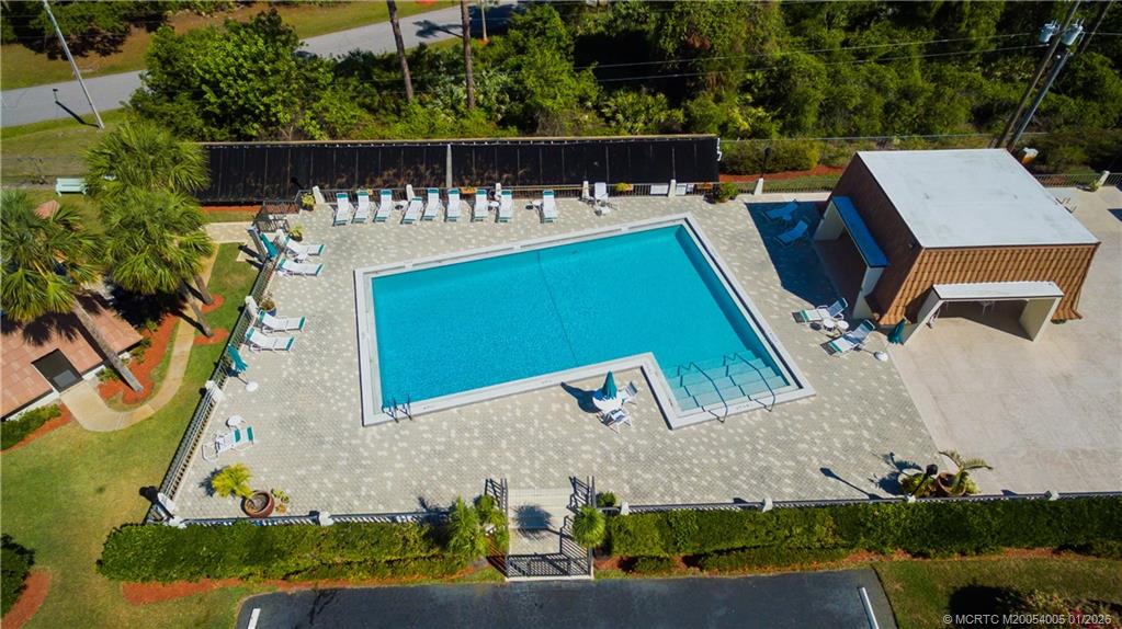 3100 Southeast Pruitt Road, Unit G205 Port St. Lucie, FL 34952 - Photo 24 of 29 an aerial view of a house with swimming pool and outdoor seating