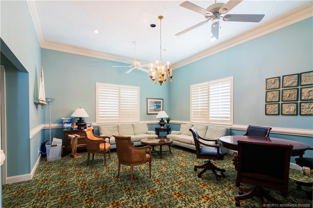 3100 Southeast Pruitt Road, Unit G205 Port St. Lucie, FL 34952 - Photo 27 of 29 a living room with lots of furniture a chandelier and a window