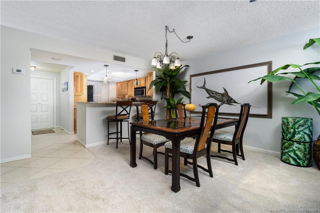 3100 Southeast Pruitt Road, Unit G205 Port St. Lucie, FL 34952 - Photo 7 of 29 a dining room with furniture and window