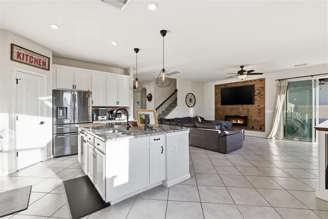a kitchen with stainless steel appliances kitchen island granite countertop a sink and cabinets
