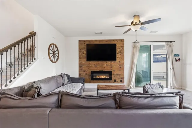 a living room with furniture fireplace and flat screen tv