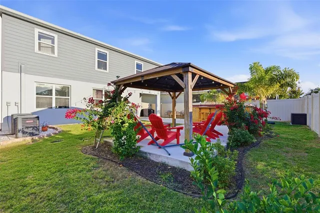 a view of a house with a yard and garden