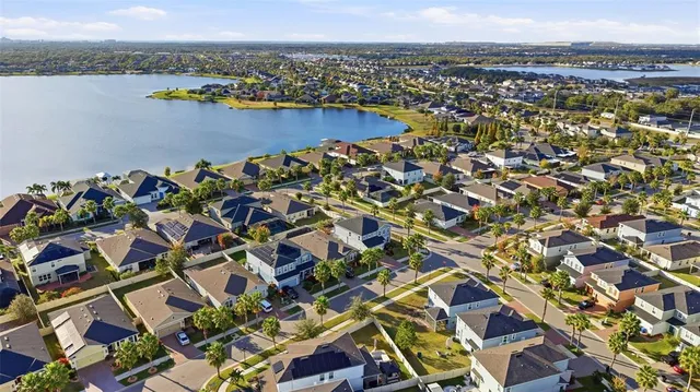 a bedroom with a large bed and a chandelier fan