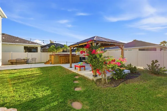 a view of a house with a big yard and potted plants