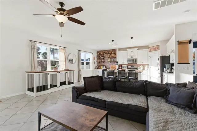 a living room with furniture and kitchen view