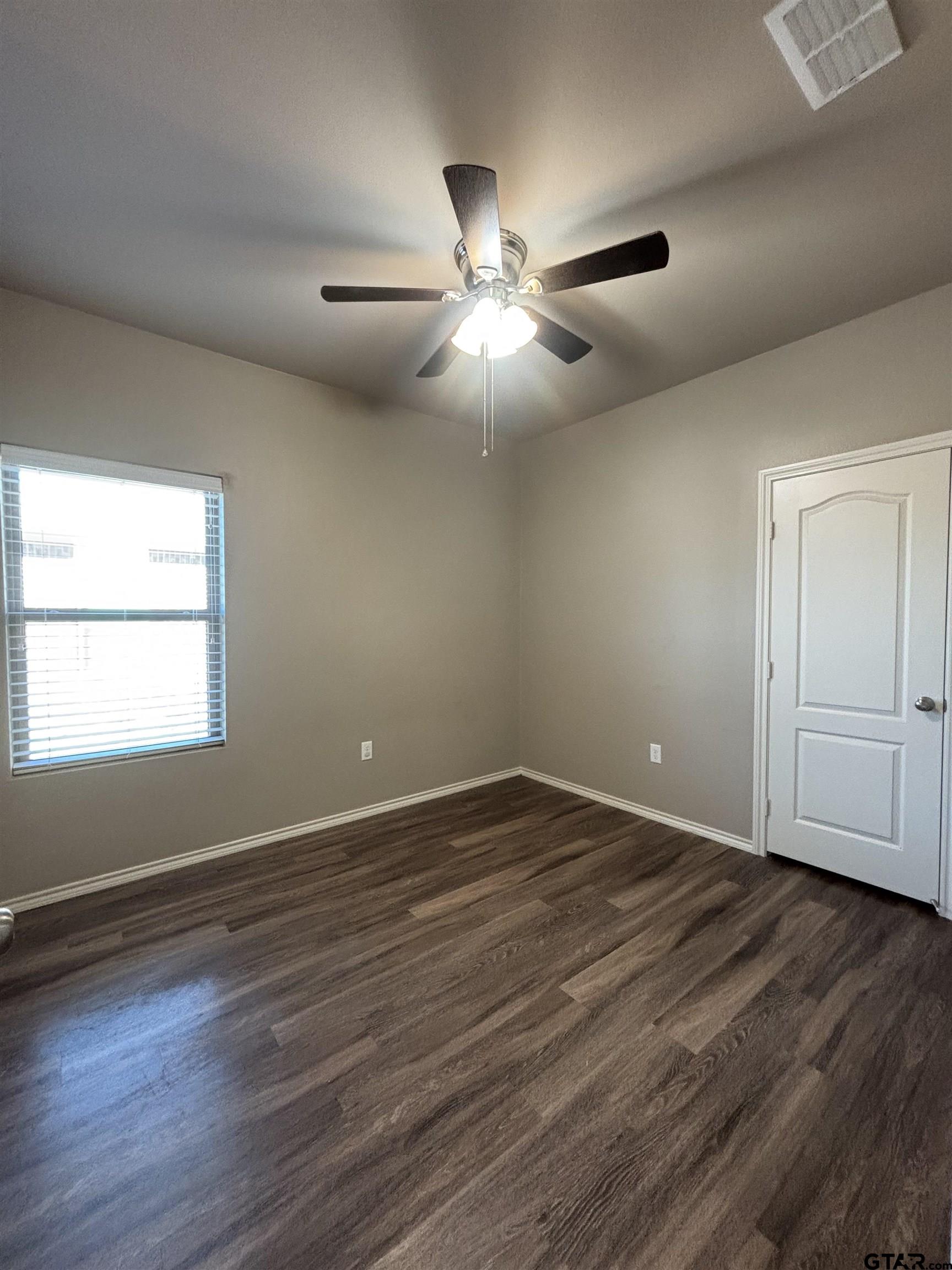 17440 Stacy Street Lindale, TX 75771 - Photo 6 of 9 a view of an empty room with wooden floor and a window