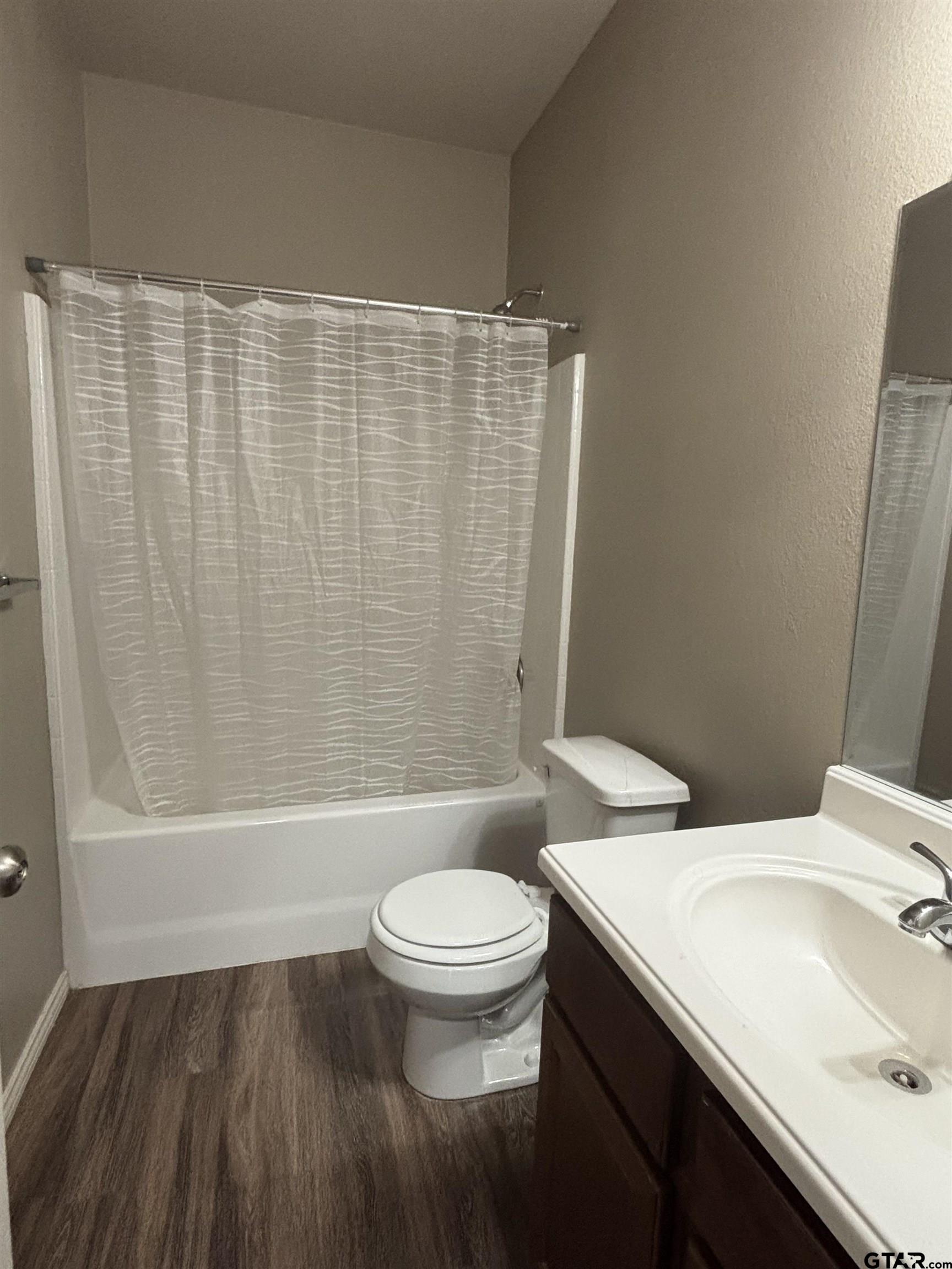 17440 Stacy Street Lindale, TX 75771 - Photo 7 of 9 a bathroom with a sink a toilet and a mirror