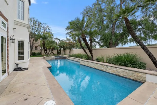 a view of swimming pool with outdoor seating and plants