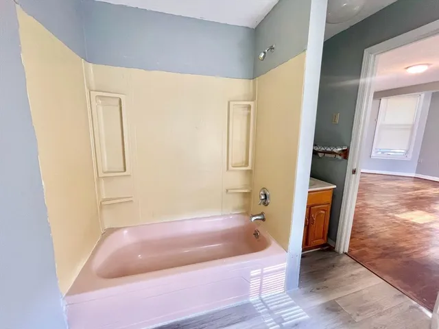 a bathroom with a tub and a shower