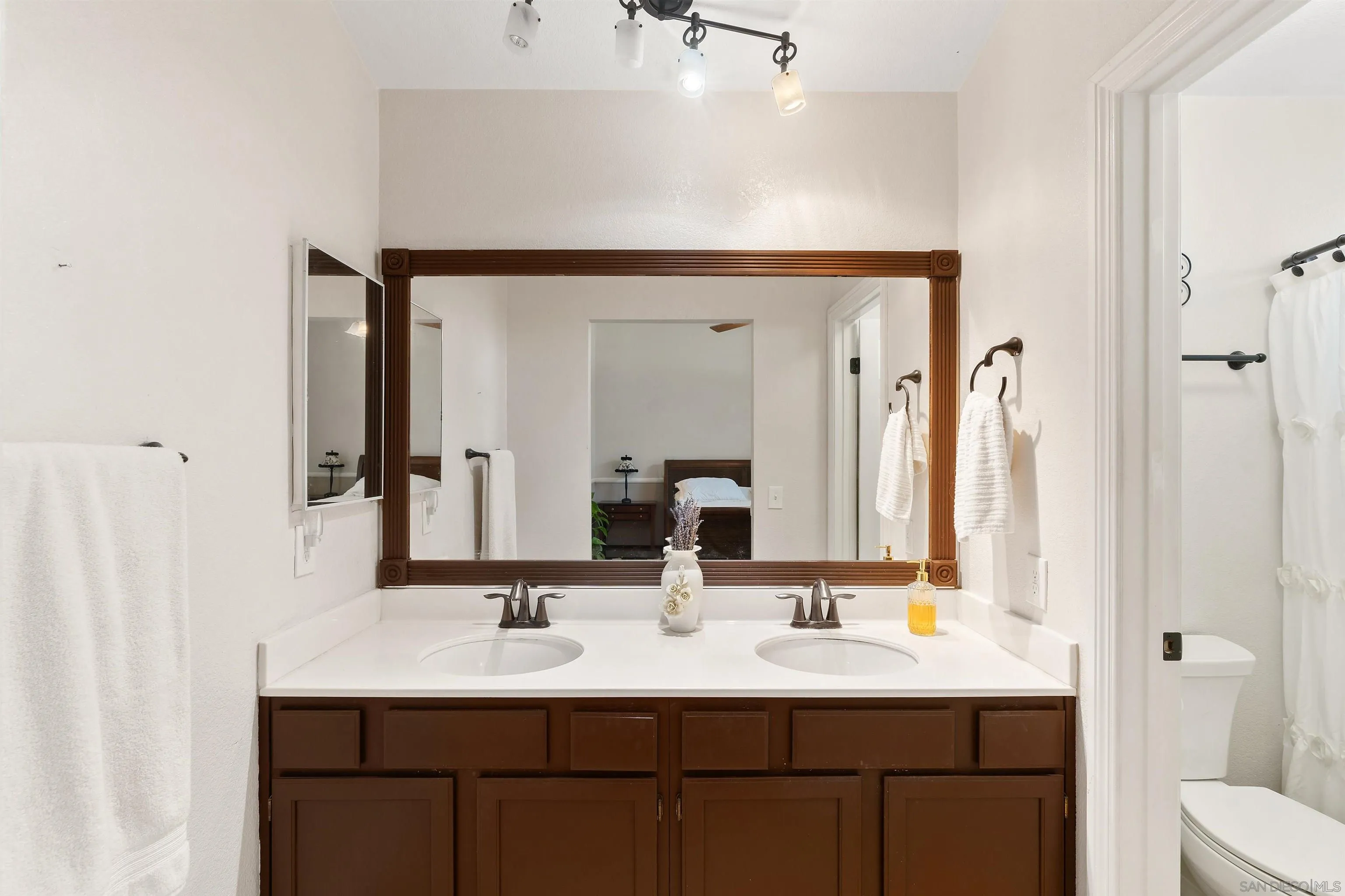43070 Corte Salamanca Temecula, CA 92592 - Photo 13 of 30 a bathroom with a double vanity sink and a mirror