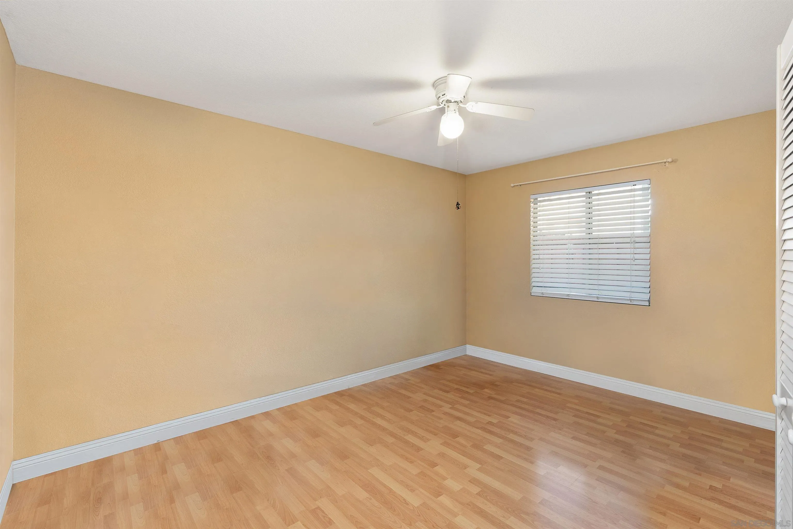 43070 Corte Salamanca Temecula, CA 92592 - Photo 14 of 30 a view of an empty room with wooden floor and a window