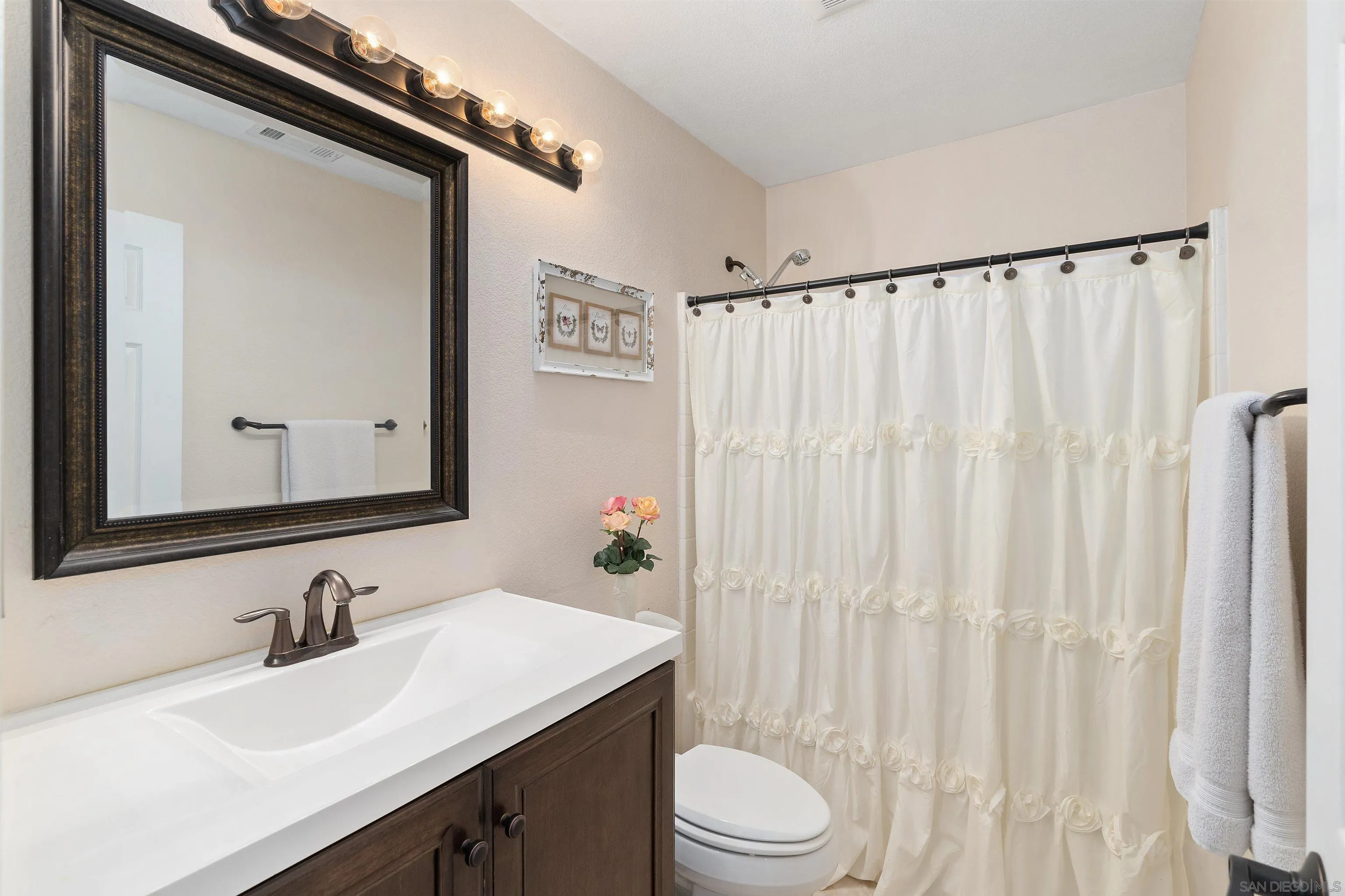 43070 Corte Salamanca Temecula, CA 92592 - Photo 16 of 30 a bathroom with a sink a toilet and a mirror