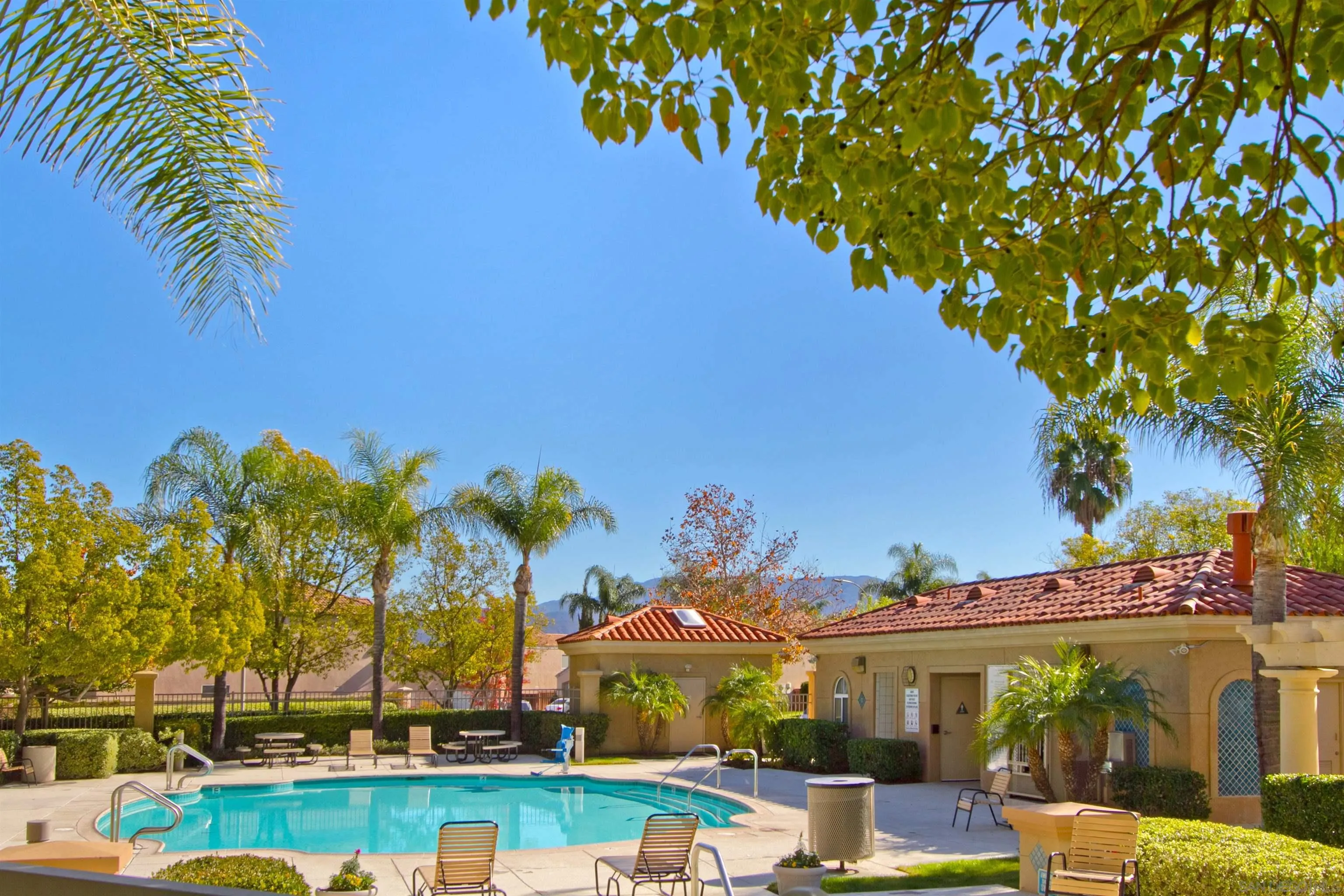 43070 Corte Salamanca Temecula, CA 92592 - Photo 24 of 30 a view of a swimming pool with lawn chairs under an umbrella