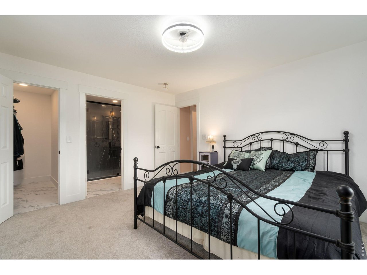 141 Tami Road Red Feather Lakes, CO 80545 - Photo 12 of 45 Primary suite with walk-in closet and deck access.