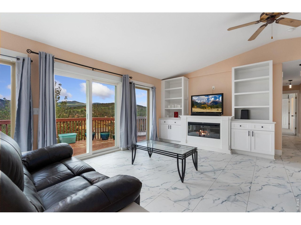 141 Tami Road Red Feather Lakes, CO 80545 - Photo 3 of 45 Custom built-ins in the great room and expansive doors overlooking the valley views.