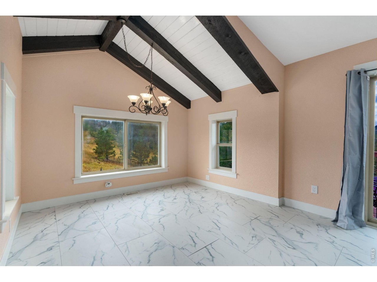 141 Tami Road Red Feather Lakes, CO 80545 - Photo 7 of 45 Dining nook with wrap around windows.