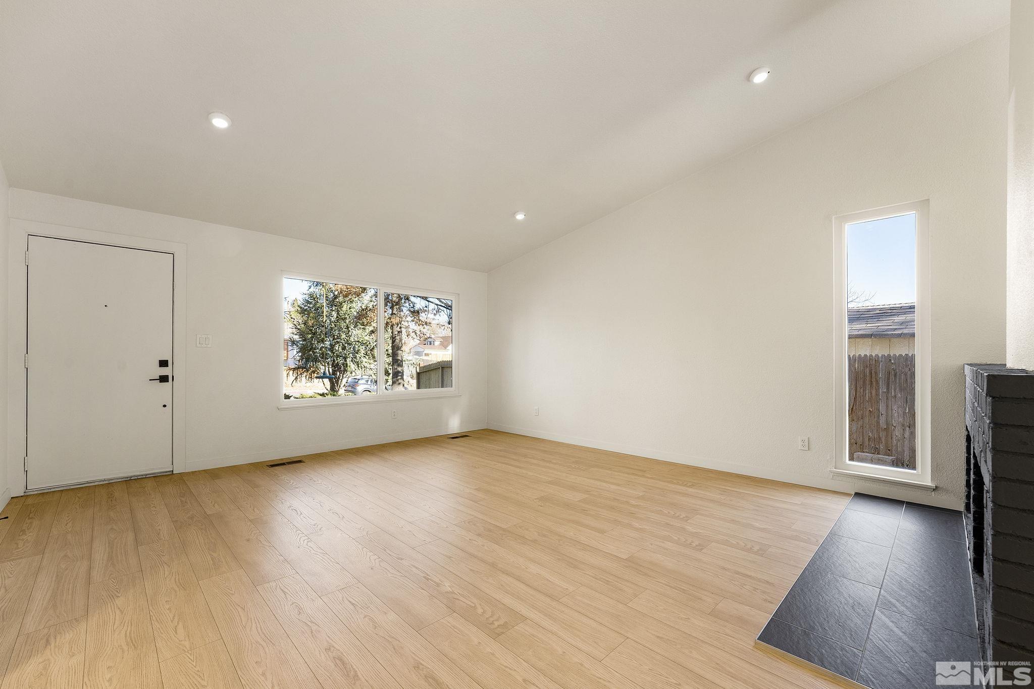 1720 Kings Row Reno, NV 89503 - Photo 11 of 39 a view of an empty room with wooden floor and a window
