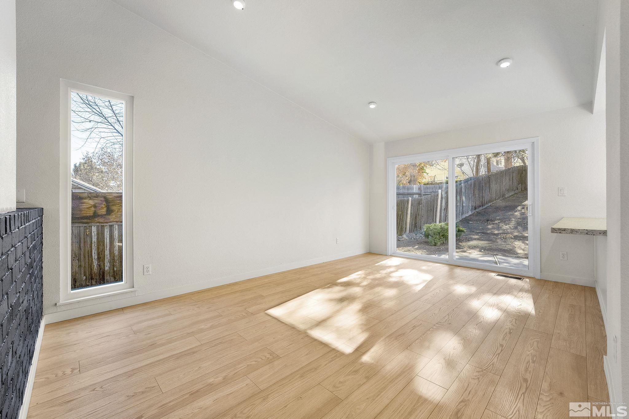 1720 Kings Row Reno, NV 89503 - Photo 12 of 39 a view of an empty room with wooden floor and a window
