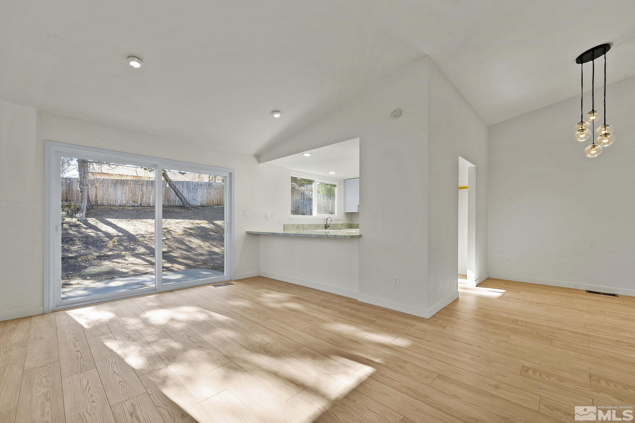 1720 Kings Row Reno, NV 89503 - Photo 13 of 39 a view of an empty room with wooden floor and a window