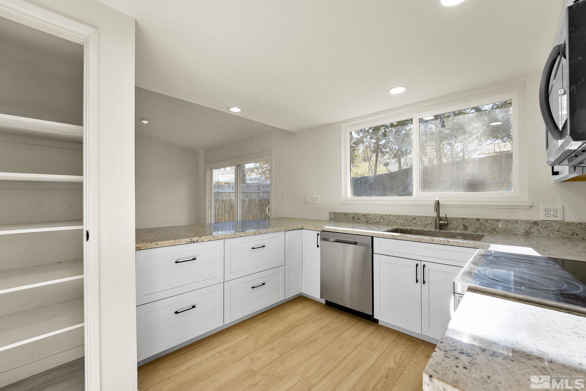 1720 Kings Row Reno, NV 89503 - Photo 17 of 39 a large bathroom with a granite countertop sink and a large mirror