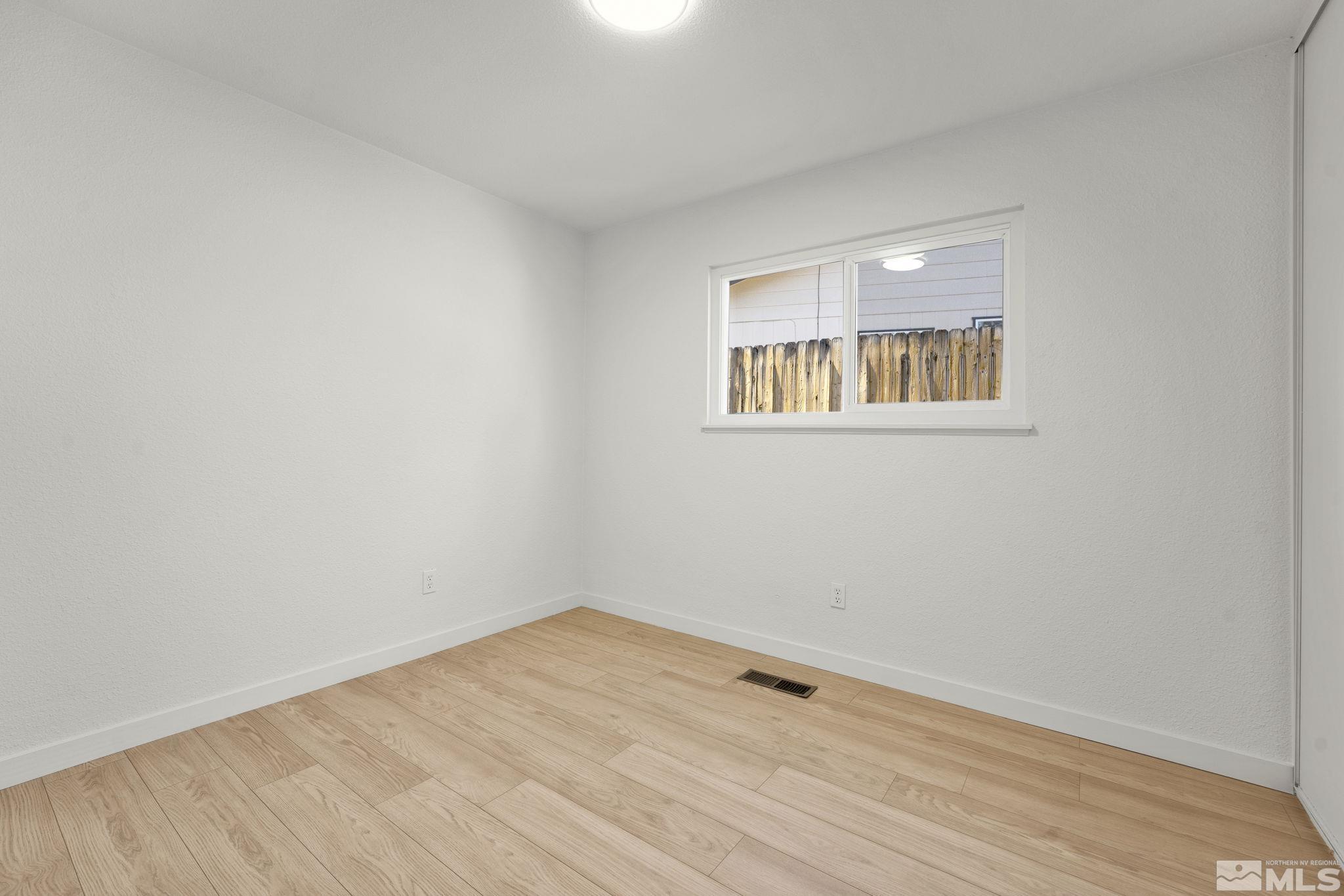 1720 Kings Row Reno, NV 89503 - Photo 28 of 39 a view of an empty room with wooden floor and a window