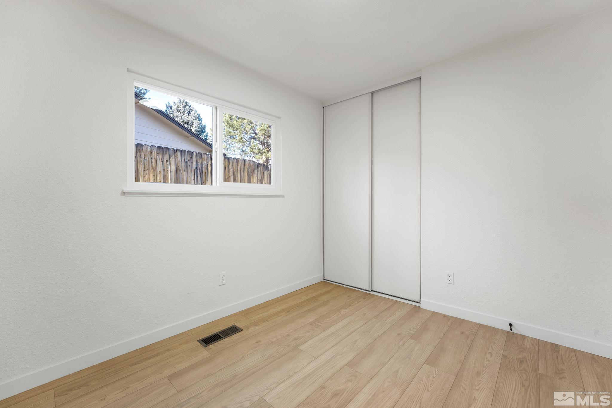 1720 Kings Row Reno, NV 89503 - Photo 29 of 39 a view of an empty room with wooden floor and a window
