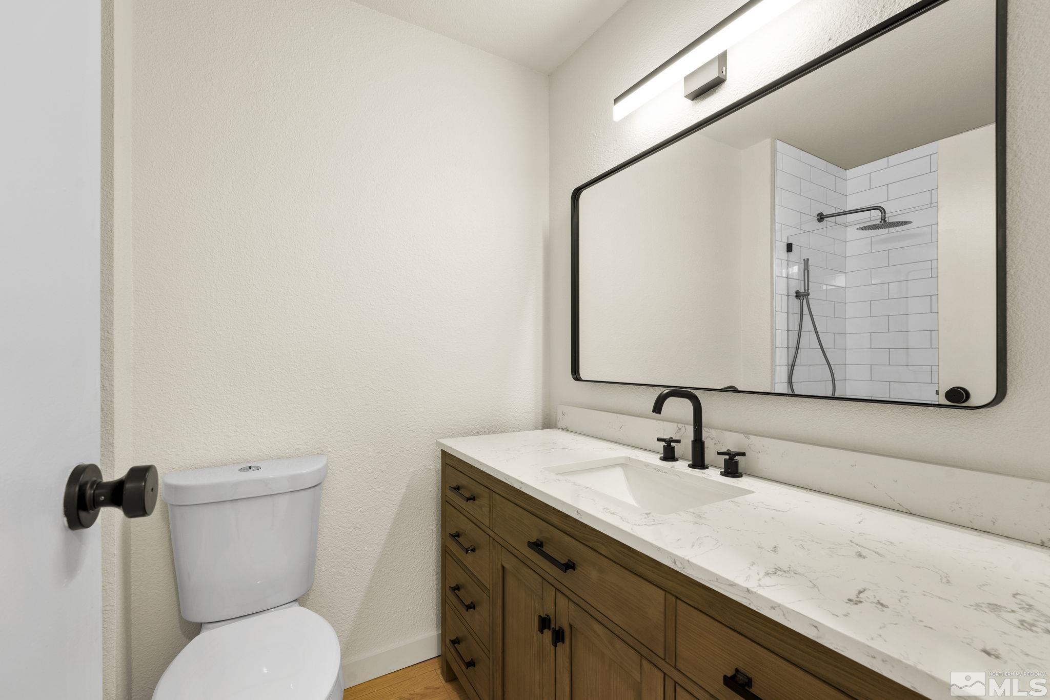 1720 Kings Row Reno, NV 89503 - Photo 30 of 39 a bathroom with a toilet sink and mirror
