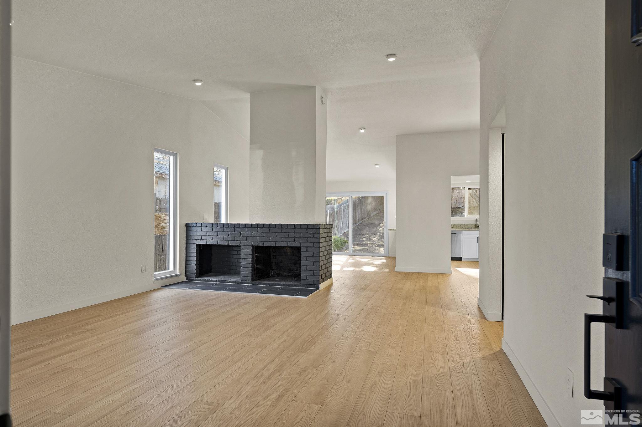 1720 Kings Row Reno, NV 89503 - Photo 6 of 39 wooden floor fireplace and windows in a room