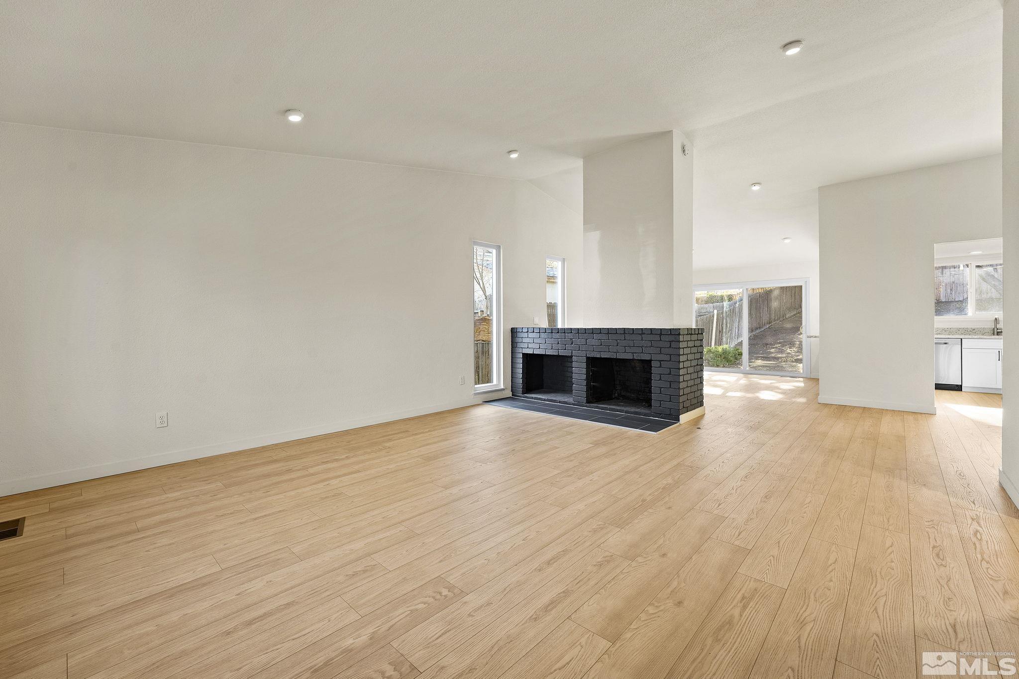 1720 Kings Row Reno, NV 89503 - Photo 7 of 39 a view of empty room with wooden floor and fireplace