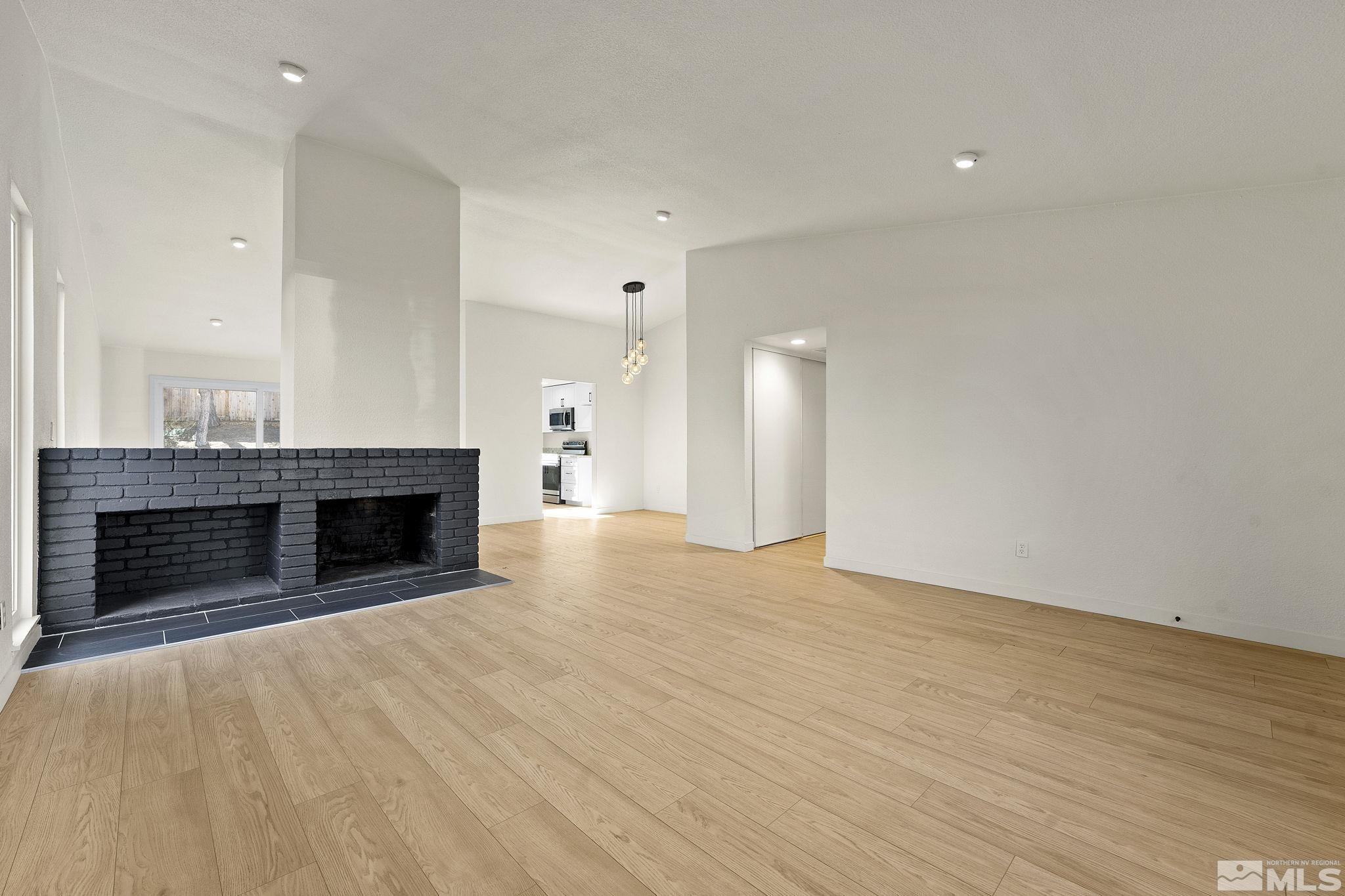1720 Kings Row Reno, NV 89503 - Photo 8 of 39 an empty room with kitchen and fireplace
