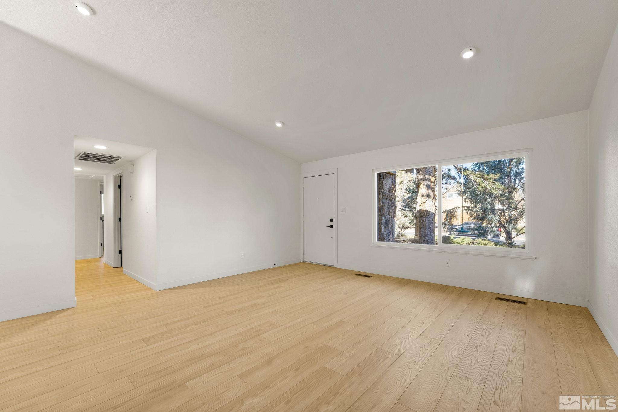 1720 Kings Row Reno, NV 89503 - Photo 10 of 39 a view of an empty room with a window and wooden floor