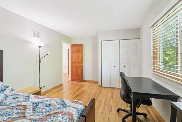 a bedroom with a bed and a table