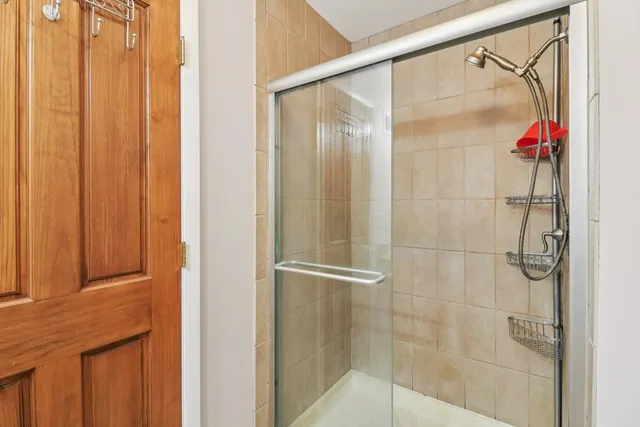 a bathroom with a glass shower door