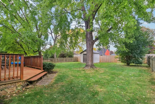 a view of backyard with a garden and deck