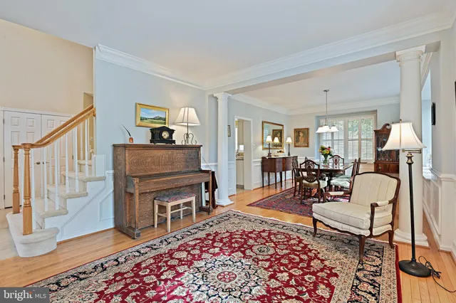 a view of a dining room and kitchen with furniture wooden floor kitchen view and a window