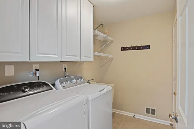 a bathroom with a double vanity sink a mirror and a shower