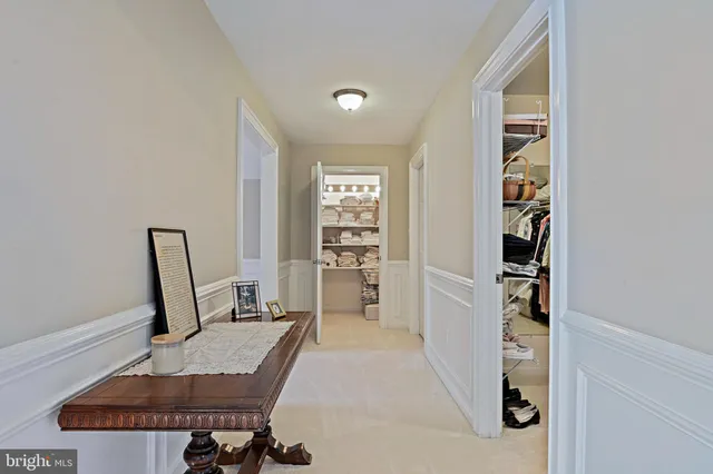 a bed sitting in a bedroom next to a window and a chandelier