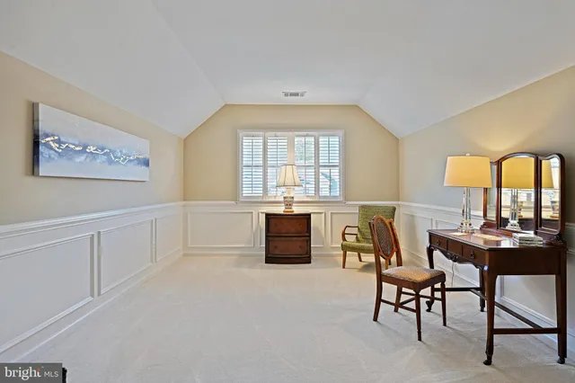 a bedroom with a bed and a lamp