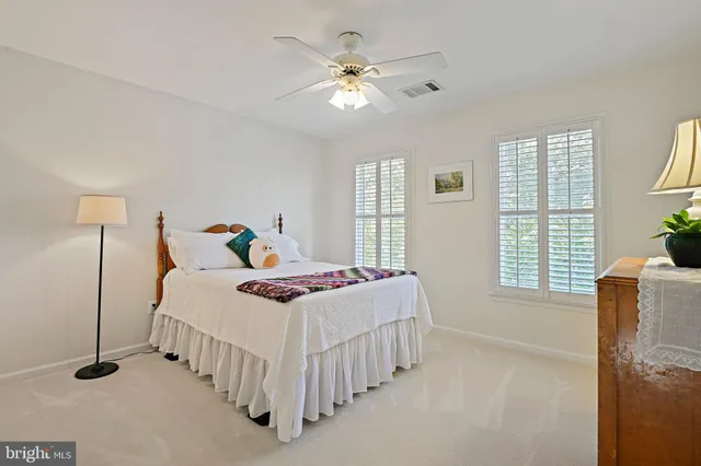 a view of a kitchen with refrigerator and white walls