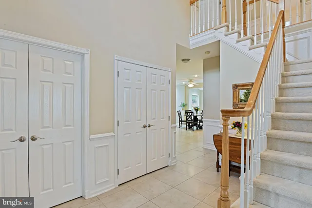 a view of a hallway with wooden floor and entryway with a dining table