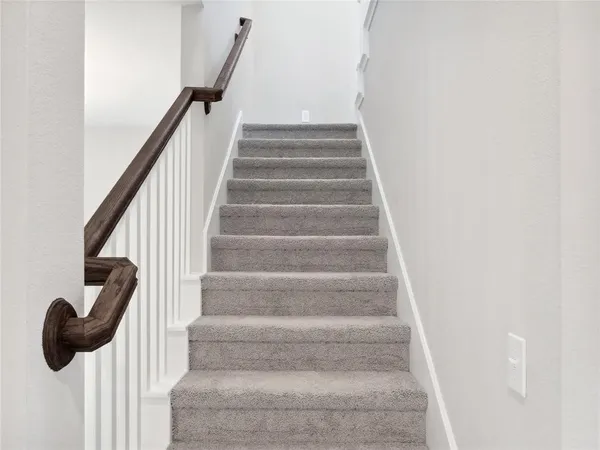 a view of staircase with white walls