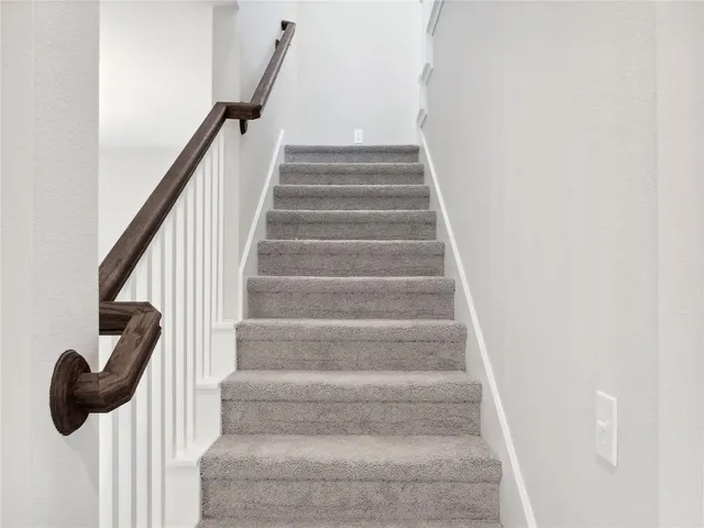 a view of staircase with white walls