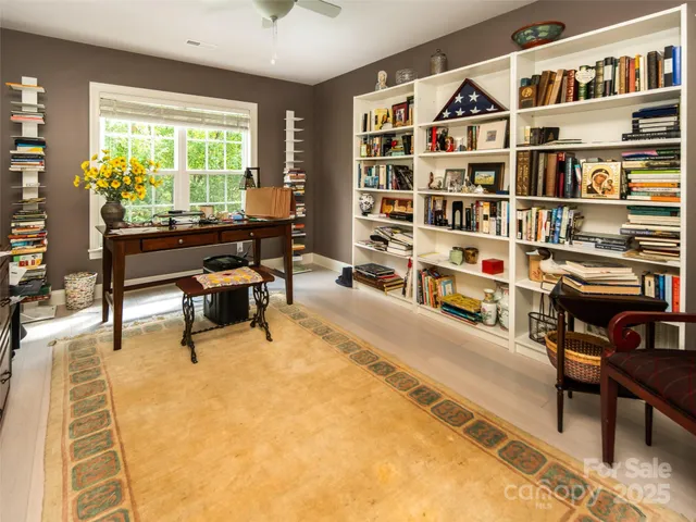 a reading room with furniture and a book shelf