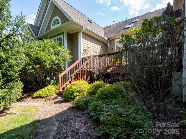 a view of a house with a small yard and potted plants
