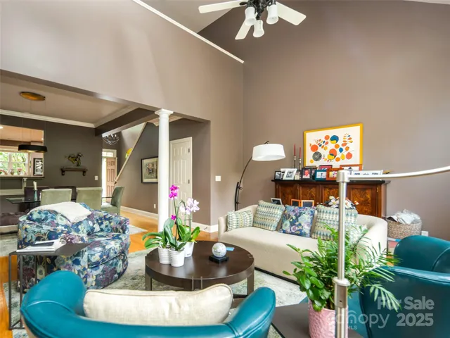 a living room with furniture and a chandelier