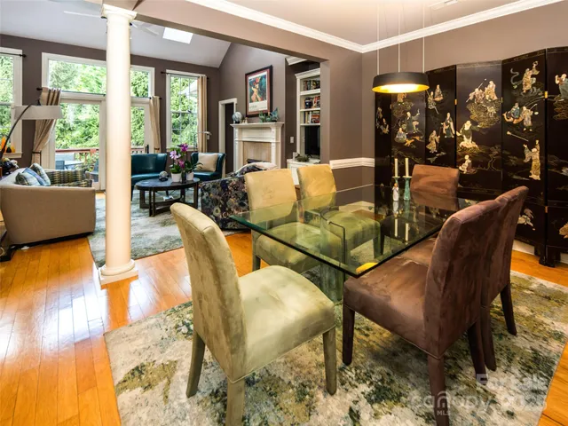 a living room with fireplace furniture and a large window