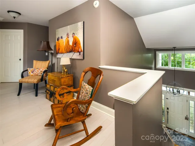 a living room with furniture and a painting on the wall